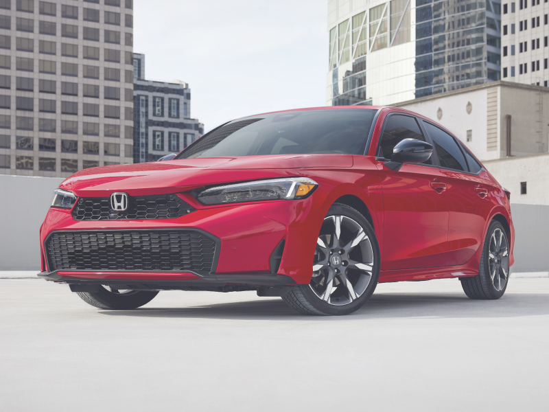 3/4 front view of red Civic Sedan parked in an empty rooftop parkade.