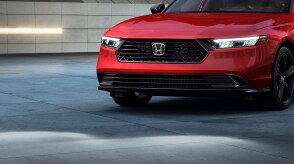 3/4 closeup of the front of a red Accord. 
