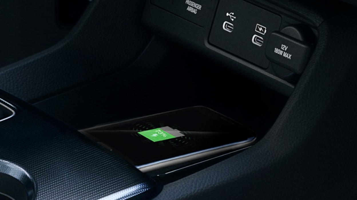 Closeup of phone charging on wireless charging pad.