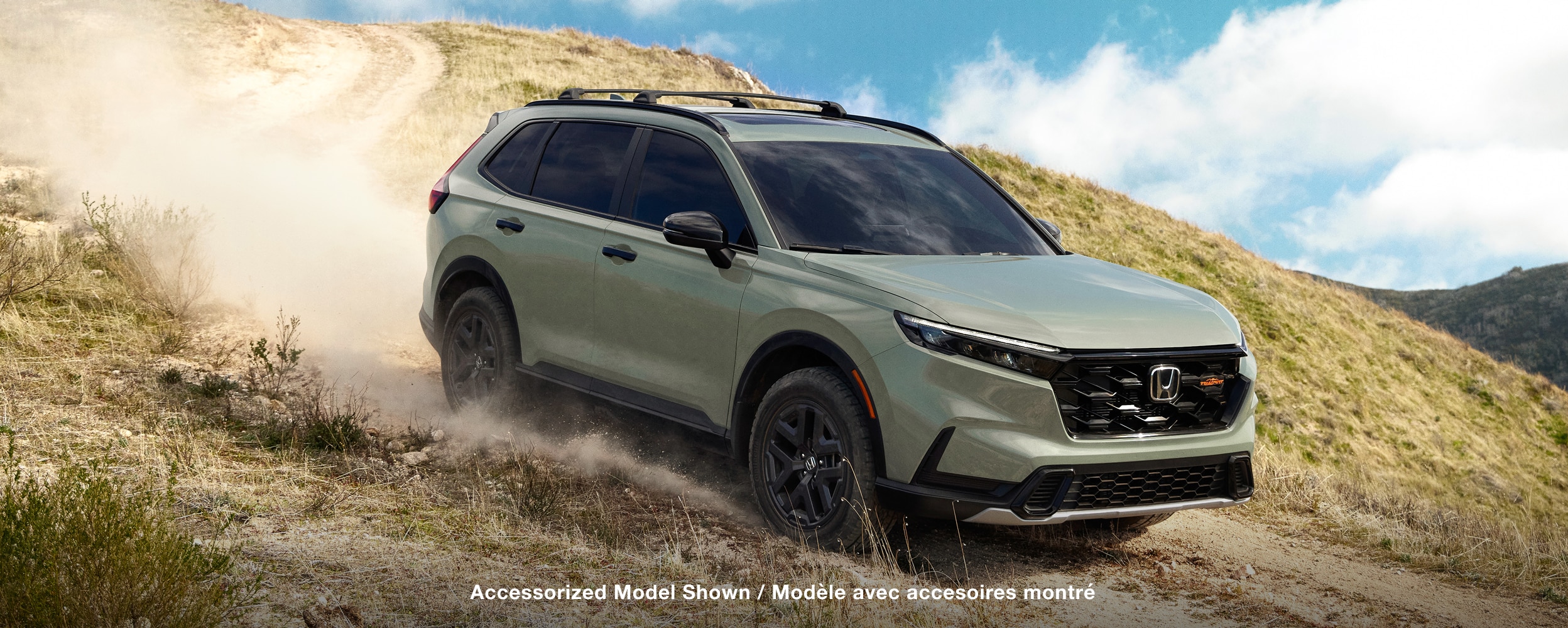 Side view of Green CR-V in a desert environment.