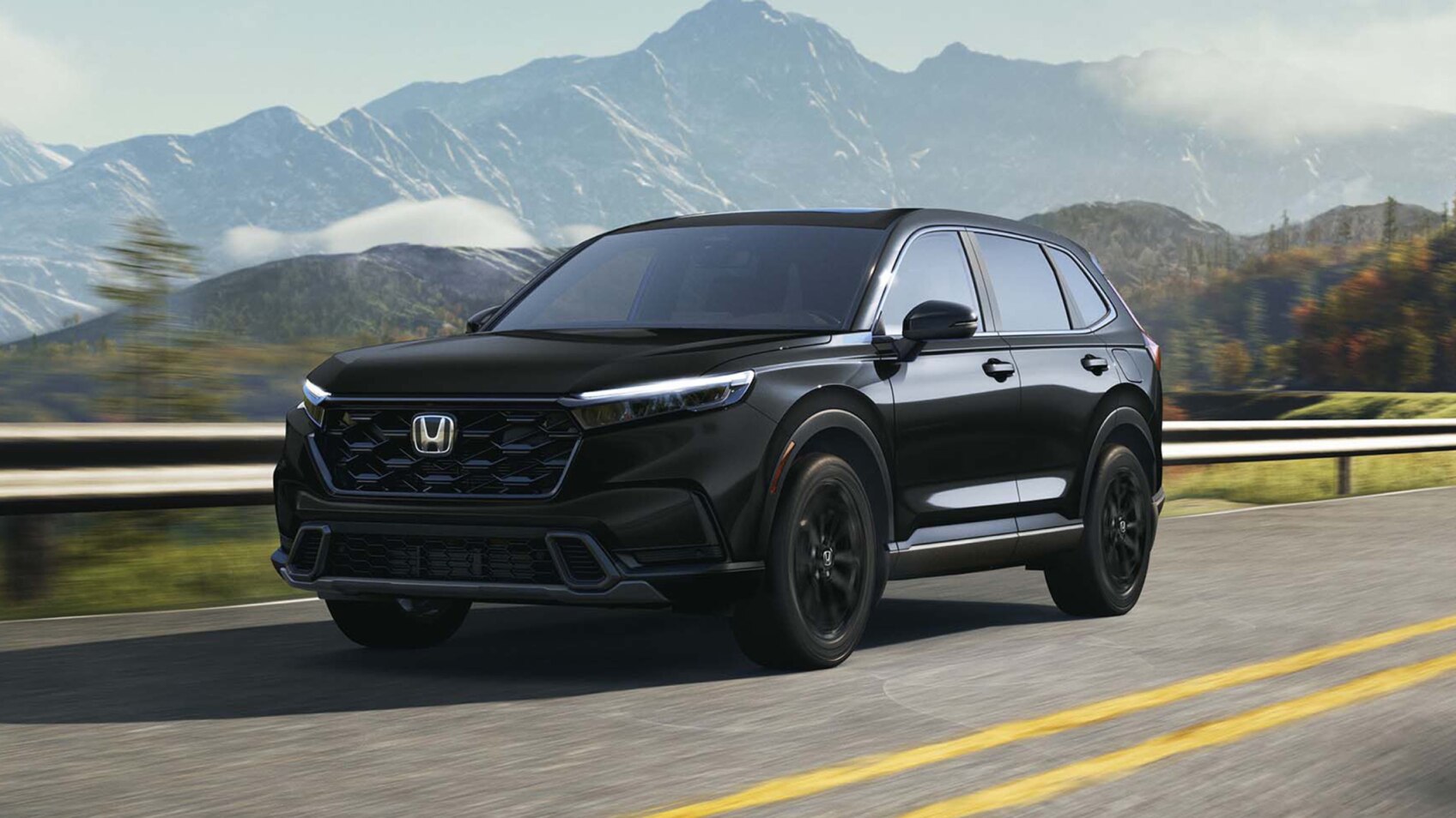 Wide shot of a black CR-V driving on a winding mountain road. 