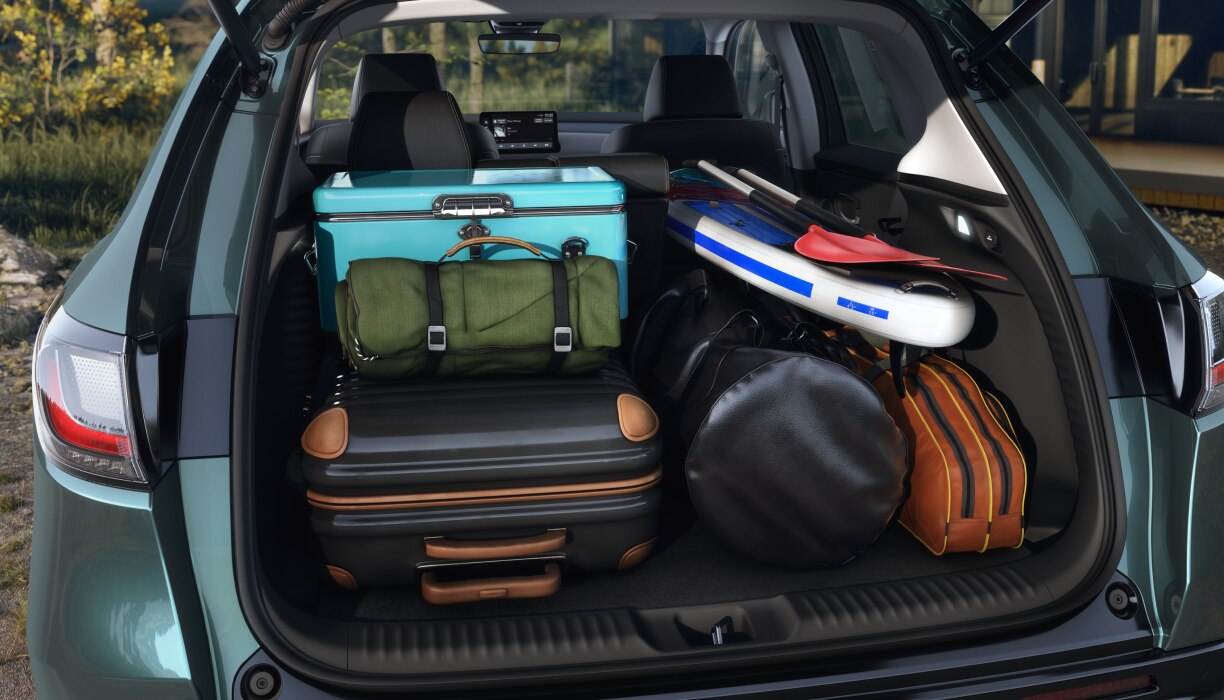 Medium closeup of open tailgate door with the cargo area full of camping and outdoor gear. 