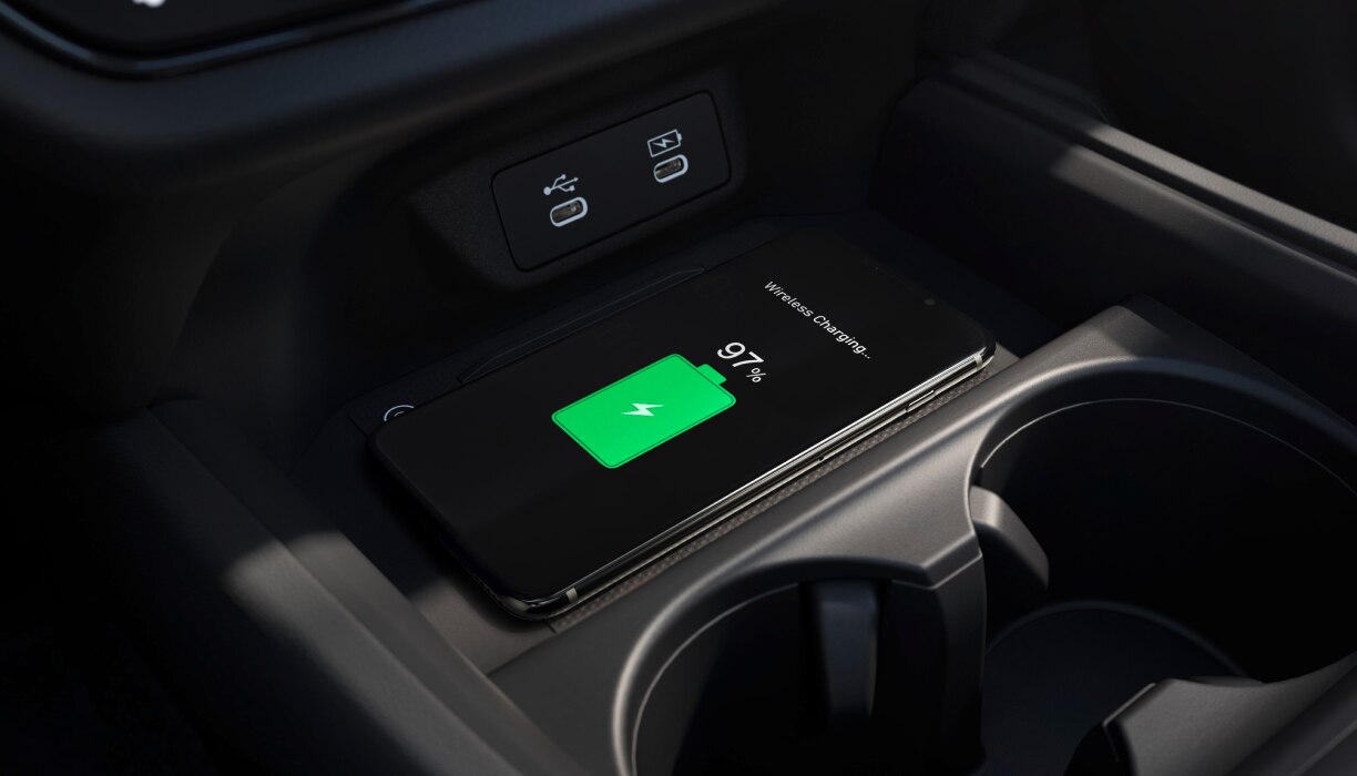Closeup of phone charging on wireless charging pad. 