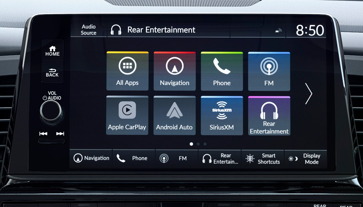 Hand pressing centre console touchscreen button.