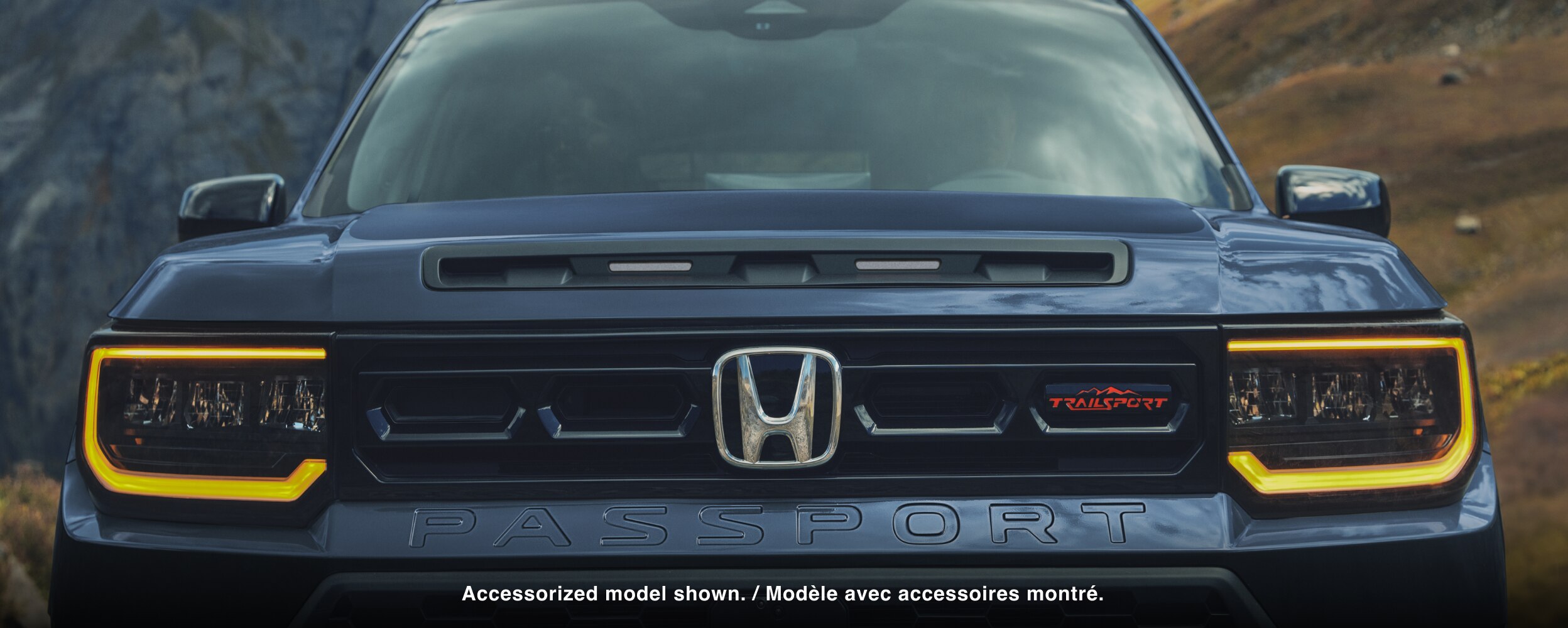 Closeup of front grill with headlights on. 