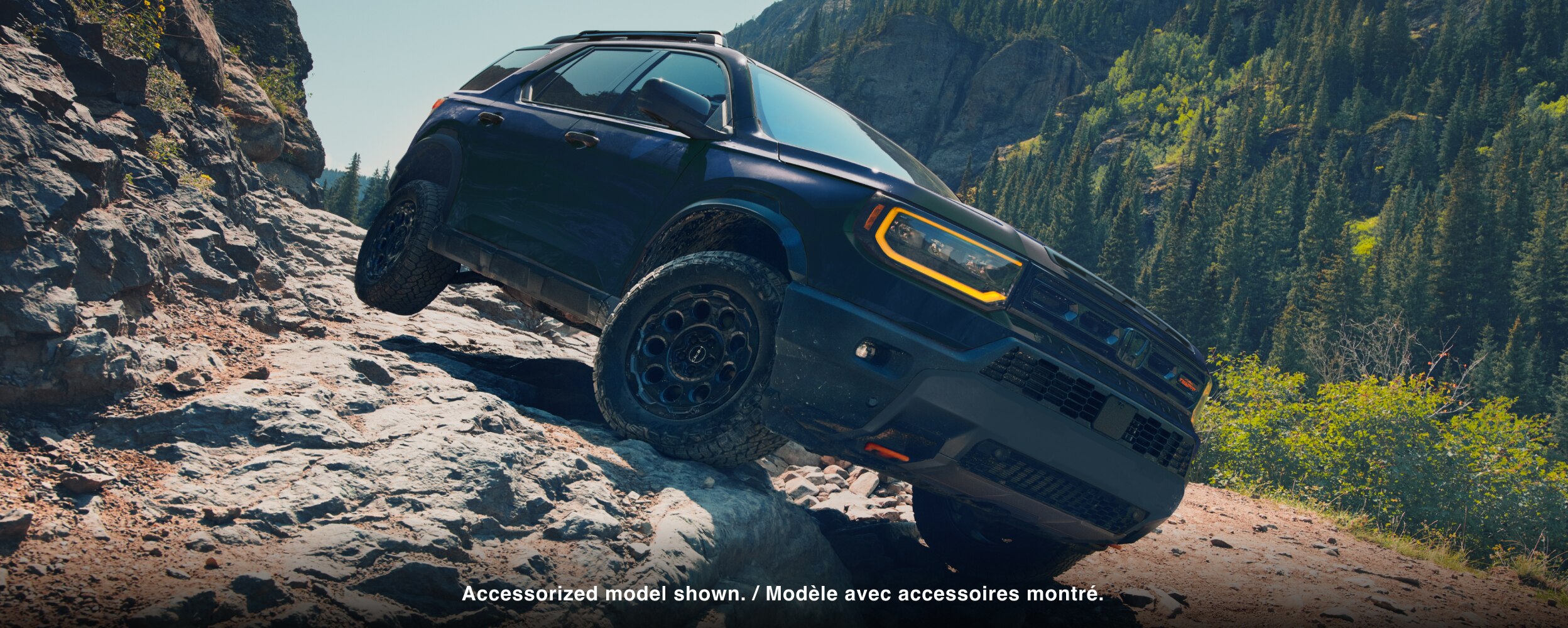 A black Passport drives over rough mountain terrain. 