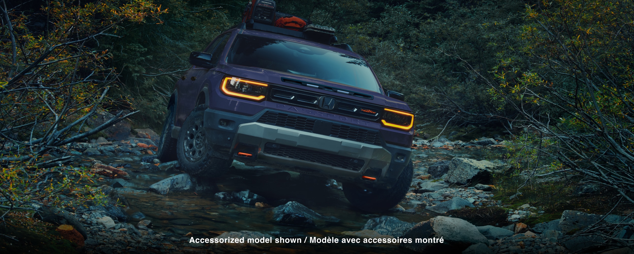 Closeup of front grill with headlights on.