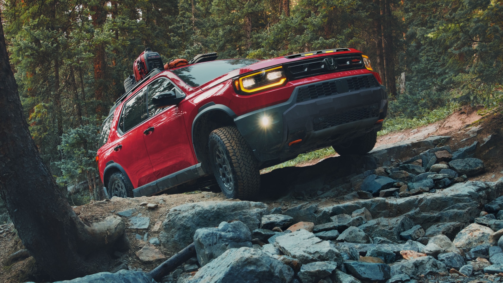 A red Passport driving on rough mountain terrain.