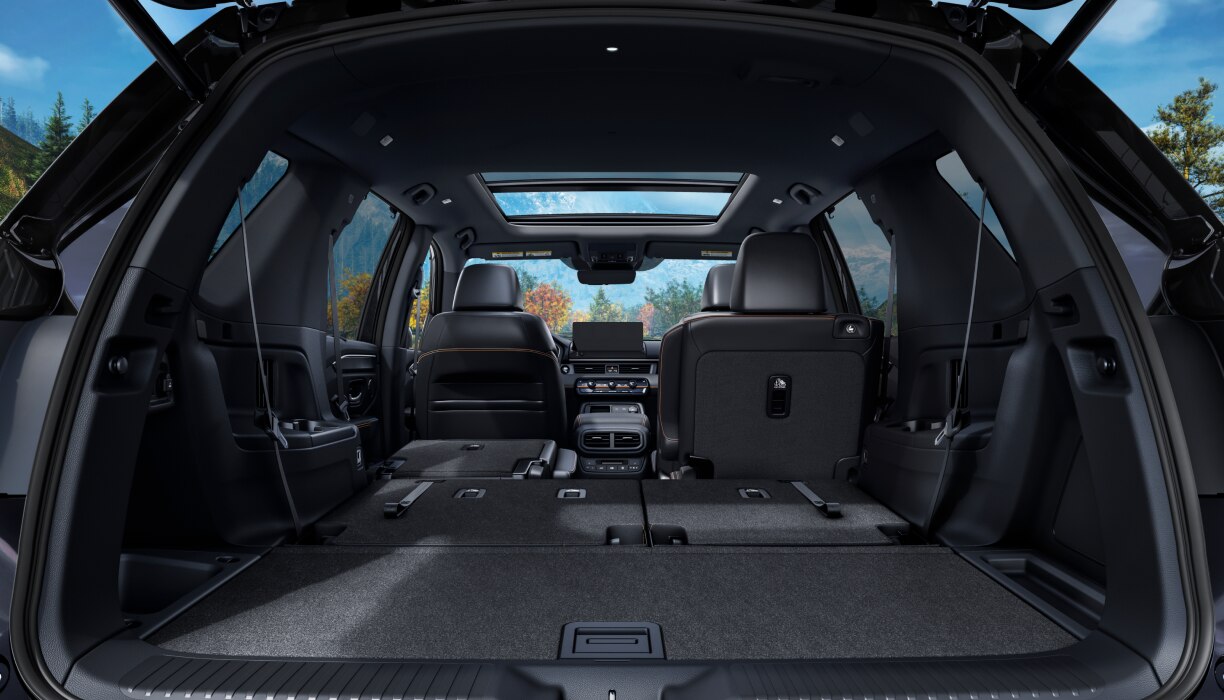 Rear view of the Pilot’s trunk interior with the back row of seats folded down.