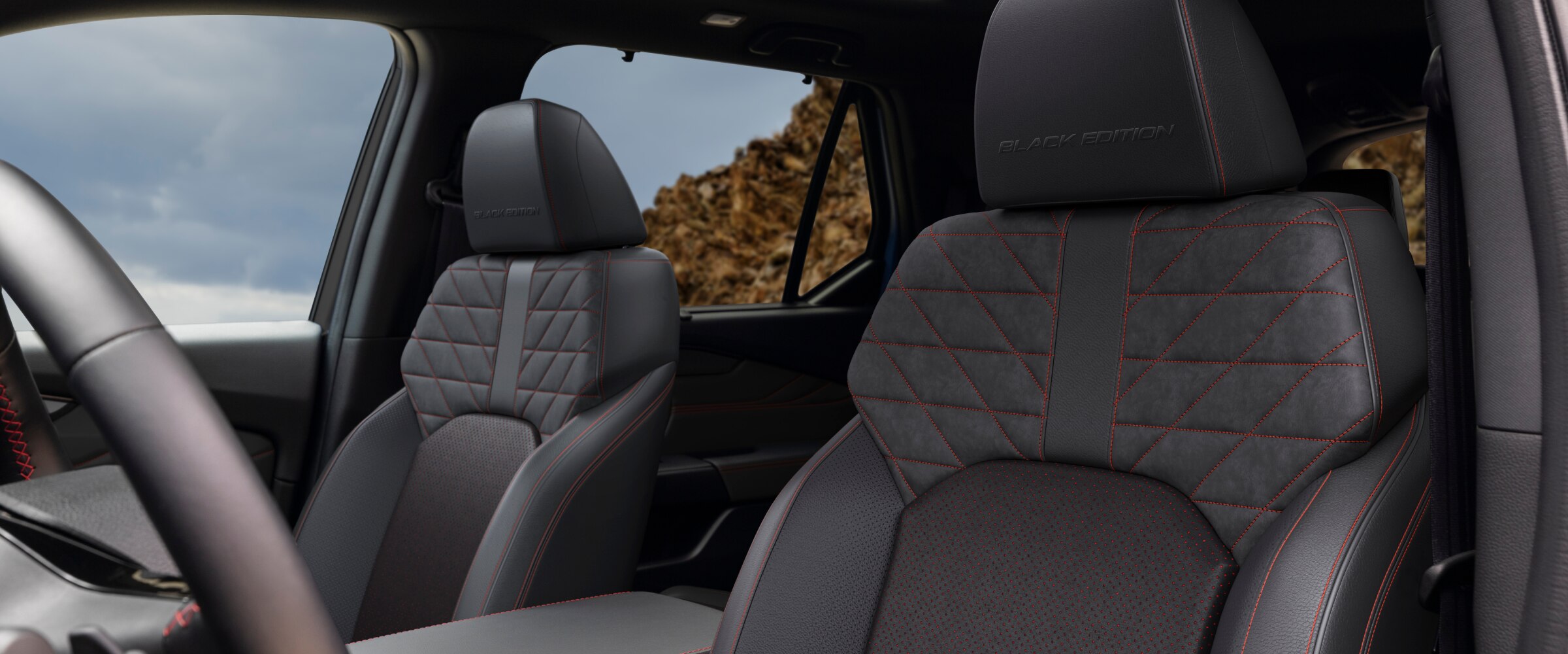 Vue intérieure des sièges avant du Pilot Black Edition, avec la mention "Black Edition" en relief sur le cuir noir.