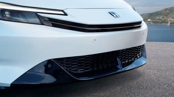 Closeup of black under-spoiler on a white Prelude. 