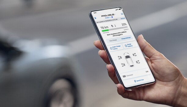 Closeup of a smartphone on white space with the HondaLink™ app interface displayed.