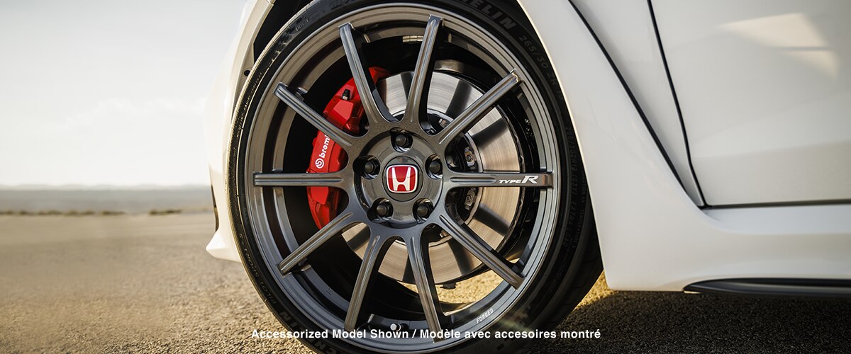 Closeup of wheel on a white Type R; Brembo® caliper is visible.