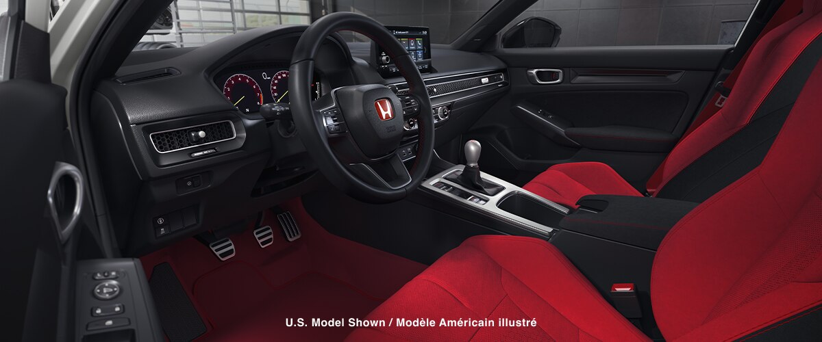 Wide shot of the cockpit, showcasing the red bucket sport seats and entire front dashboard.