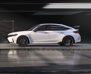 Side view of white Typr R in an auto hangar.