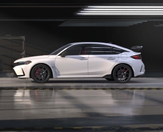 Side view of white Typr R in an auto hangar.