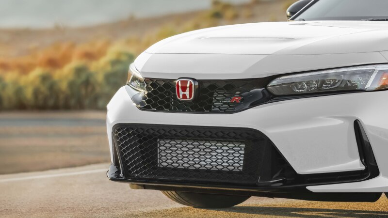 3/4 closeup of a Type R’s red “Honda” logo and “Type R” badging.